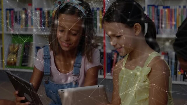 Two girls in education left girl laughing, tapping sharing tablets, comparing screens with network