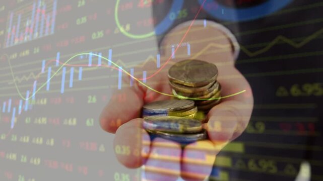 Businessman presenting coins, finance charts overlaying coins and showing market performance