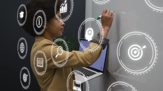 Woman resting laptop on shelf raising green marker, writing board while AR icons guiding business