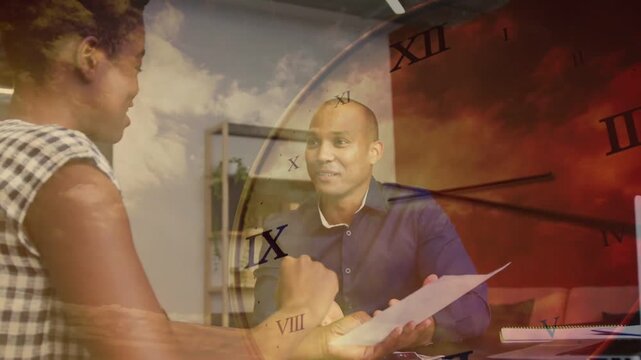 Woman handing paper across desk causing business review under clockface sky overlay ending highfive