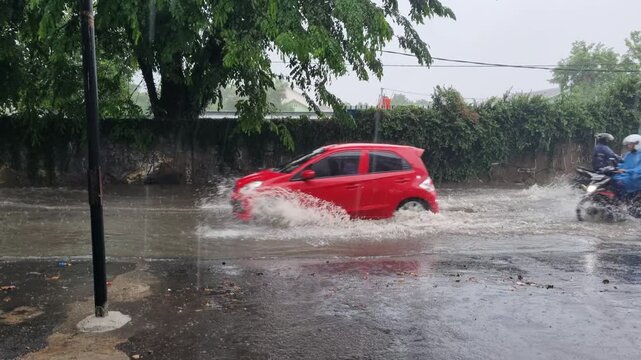 vehicles crossing flood water