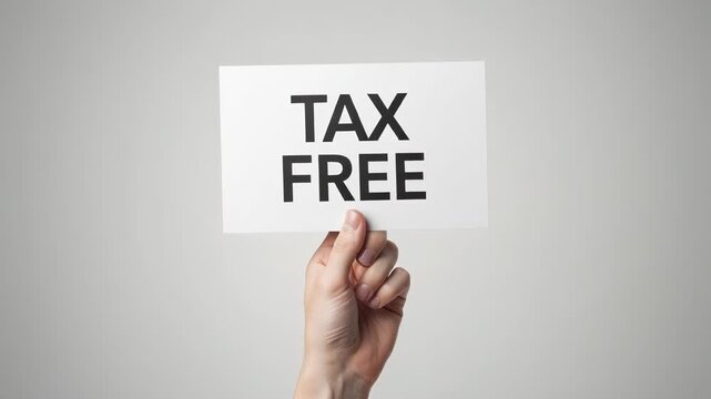 Hand holding tax free sign on white paper against light background for shopping and savings concept