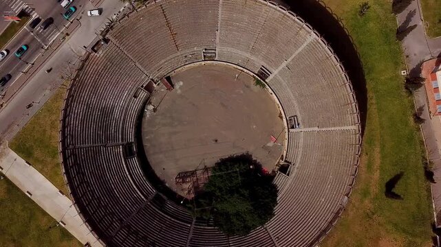 Vertical drone view of the historic Spanish bullring arena in Tangier, Morocco, revealing the circular architecture of the old Plaza de Toros.