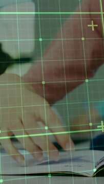 Vertical video: Student studying, writing notes with blue pen, picking phone as grid spanning frame