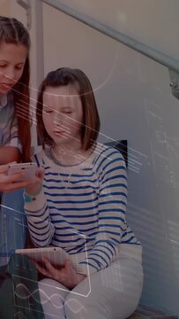 Vertical video: Seated teen holding tab friend showing phone tapping sharing tech AR UI over them