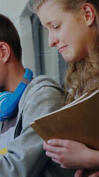 Vertical video: Teen student reviewing notes by school window glancing at peer's device smiling