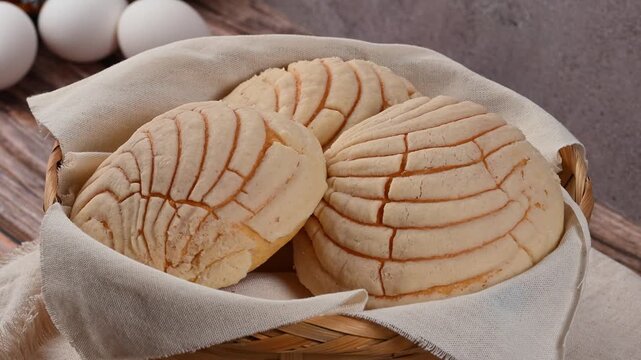 Traditional Mexican sweet bread known as Concha in a rotating wicker basket