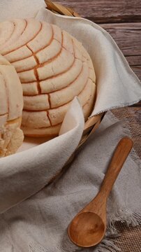 Authentic vanilla conchas Mexican pastry on a rustic wooden background