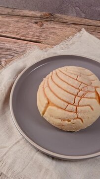 Traditional Mexican bread, vanilla concha served on a minimalist plate