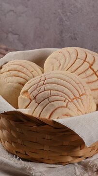 Rustic breakfast still life with Mexican conchas on a rotating basket