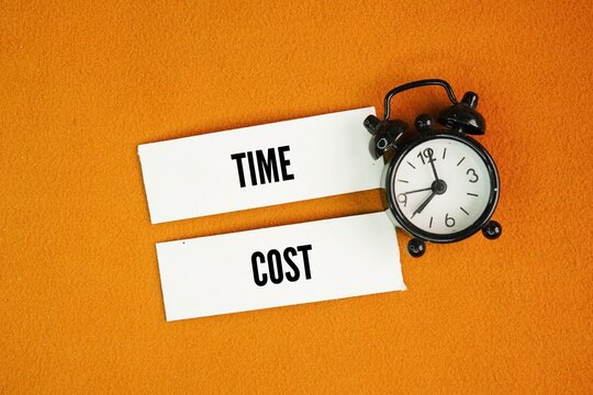 A bell clock with two words Time and cost are critical, interconnected components of the project management triple constraint along with scope, where shortening schedules generally increases expenses 