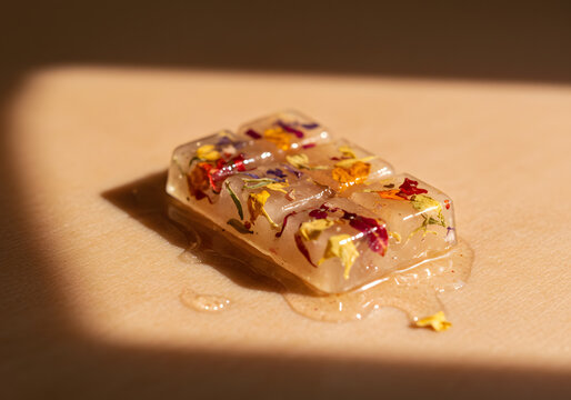 Floral ice cubes on beige surface