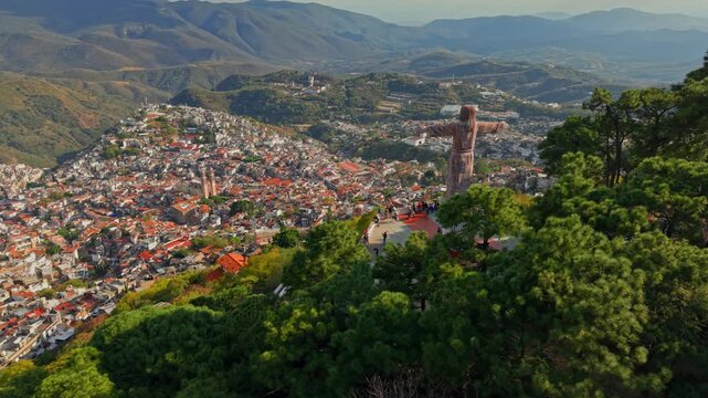 Static panoramic aerial view of the monumental Christ statue in Taxco protecting and watching over the city of Taxco, Guerrero, Mexico. High frame rate.