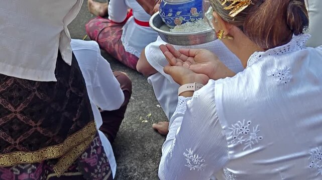 Balinese Hindu Devotees Receiving Holy Water Nunas Tirta During Ceremony
