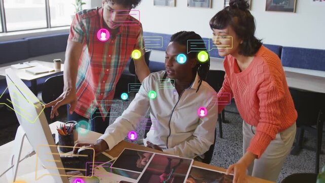 Vertical video: Design team pointing and using mouse sparking social icons around prints for review