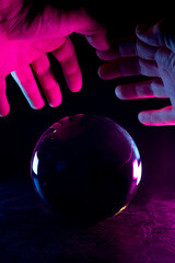 Hands over crystal ball on dark background mystical concept Hands over crystal ball on dark...