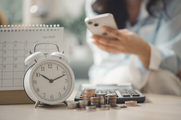 Smartphone bill payment reminder with calendar, alarm clock and coins representing recurring...