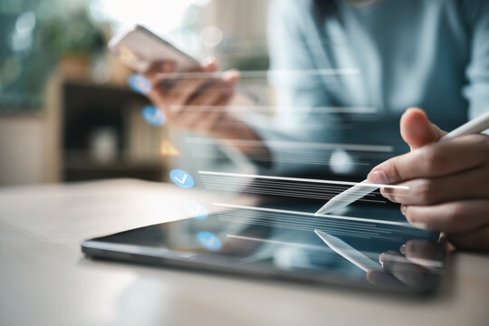 User reviewing account login activity and session history on tablet and smartphone. Concept of cybersecurity monitoring, suspicious login detection, identity verification.