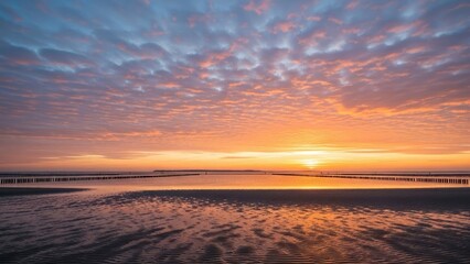 Fototapeta premium A serene sunset over a calm body of water with a vibrant sky