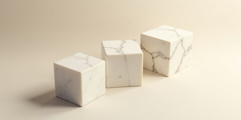 Fototapeta premium Elegant Cubic Marble Display Three off-white marble cubes of varying sizes arranged on a neutral background, showcasing subtle veining and texture.