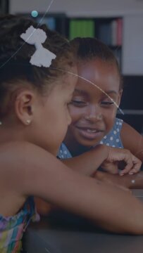 Vertical video: Two girls leaning and tapping table, causing dot line overlays for education