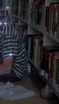 Vertical video: Teen studying in library, reaching for device while glowing nodes linking to notes