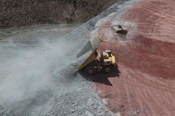 Aerial view of a mine waste dump with a mining dump truck unloading rocky material © WILL PHOTOGRAPHY