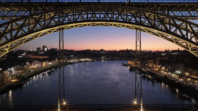 Sunset Dom Luis I Bridge At Porto In District Of Porto Portugal. Sunset Skyline Scene. Illuminated Bridge Landscape. Dom Luis I Bridge At District Of Porto Portugal. Railroad Transport.