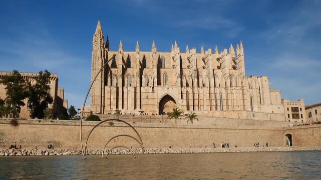 Static shot of Cathedral-Basilica of Santa Maria of Mallorca with a pond in the foreground. Palma de Mallorca, Spain.