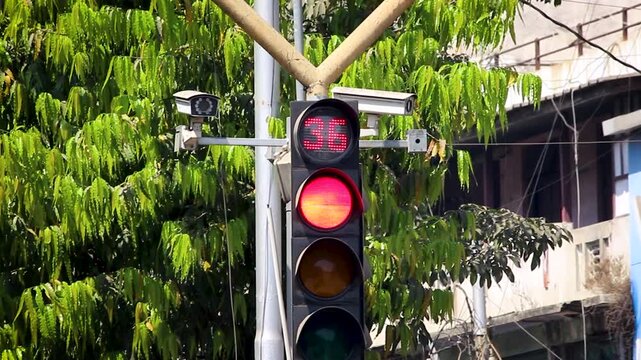 Traffic signal red light countdown timer at busy urban intersection India, digital timer showing seconds for stop control, road safety, smart traffic management system.
