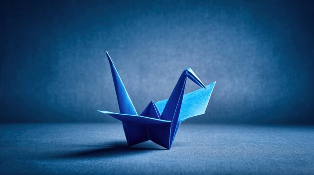 A blue origami crane stands against a dark blue backdrop, creating a calming atmosphere