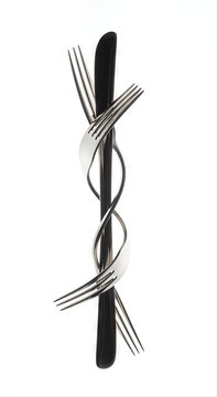 Artistic composition of a bent fork elegantly twisted around a knife, isolated on a pristine white background