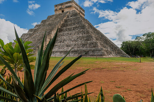 Ancient Mayan pyramid rises under blue sky