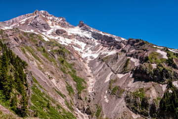 Fototapeta premium Rugged mountain peak gleams under clear blue sky