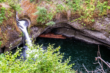 Waterfall cascades into deep, serene pool below © ExploringandLiving