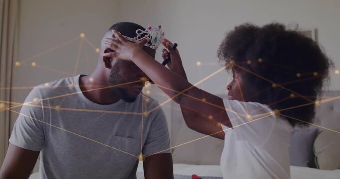 Father leaning while daughter reaching placing tiara and brushing face, bonding under tech overlay