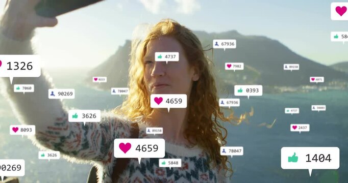 Woman raising phone for selfie on coast posing as social likes growing around her, camera closing