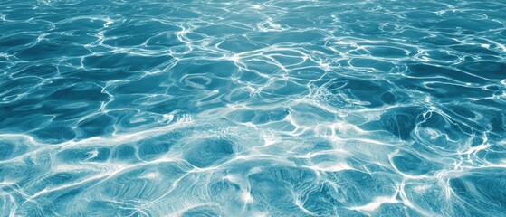 Fototapeta premium A serene view of clear blue water, showcasing gentle waves and reflections, evoking a sense of calm and tranquility.