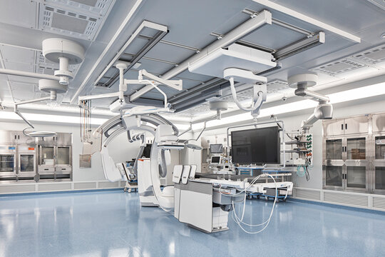 Bright interventional suite with large imaging machine and sterile finish