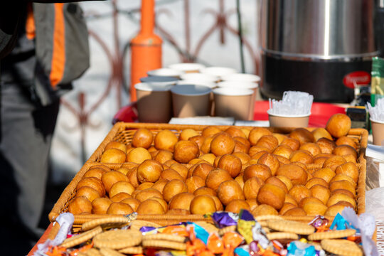 Delicious golden baursak donuts in wicker basket at outdoor street food festival