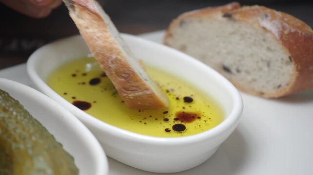 Enjoying bread with olive oil and balsamic vinegar dip