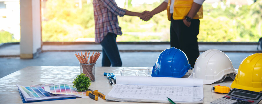 Banner Contractor construction engineer meeting on architect table at construction site. Businessman engineer manager discuss talk together foreman team builder using measure tape with copy space