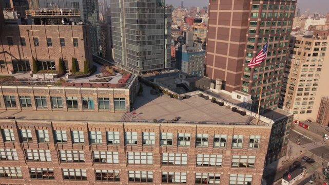 flying counter clockwise around American flag at corner of Canal and 6th Ave. in NYC