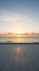 Fototapeta premium Serene ocean sunrise viewed from a modern balcony with tiled flooring and glass railings, casting a peaceful glow over the calm water and sky.