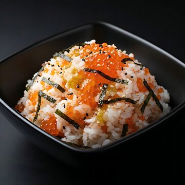 A bowl of al bap 알밥 (fish roe rice) with flying fish roe, seaweed, and sesame oil, served in a black bowl against a black background. emphasizes the bright orange roe and glossy rice,
