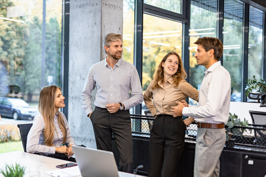 Group of happy progressive business people working on startup together at creative office