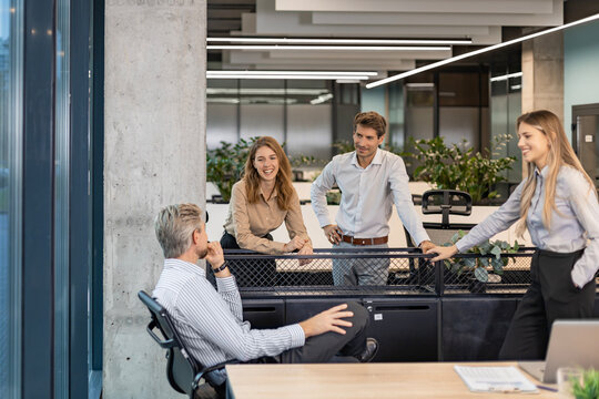 Group of happy progressive business people working on startup together at creative office
