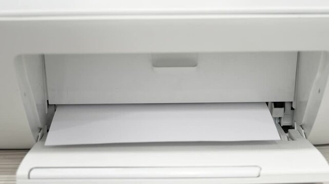 A person works on a printer that has a paper jam. The video shows steps to open the printer, check for stuck paper, and clear the jam. Troubleshooting continues for better printing.