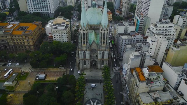 Stunning drone footage captures the iconic Catedral Metropolitana da S&eacute; with its distinctive green copper dome surrounded by S&atilde;o Paulo's urban architecture and historic downtown buildings.