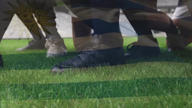 Animation of flag of uruguay over diverse male rugby players playing at stadium